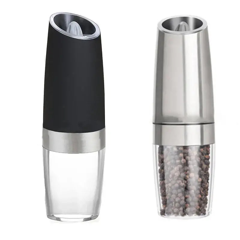 Modern black and stainless steel electric salt pepper grinder with clear base containing peppercorns for kitchen use
