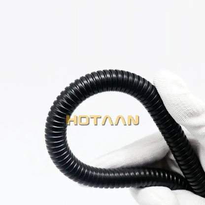 Black corrugated plastic conduit held in white glove representing flexible shower hose black stainless steel pipe