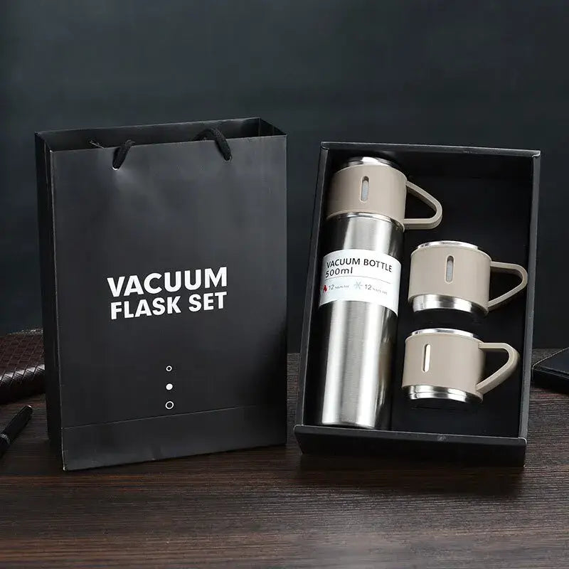 Silver stainless steel vacuum insulated water flask with beige lid and mugs in modern insulated water bottle gift set
