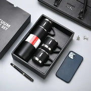 Modern black stainless steel insulated water bottle gift set with vacuum insulated water flask and matching mugs in box