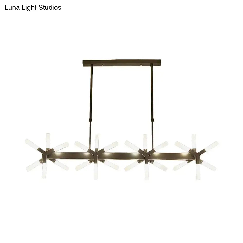 Modern bronze-finished pendant light with four starburst glass arms and linear acrylic shade for dining room lighting
