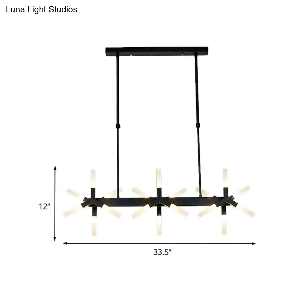 Black metal chandelier with three starburst-style warm lights featuring linear acrylic shade ideal over dining island