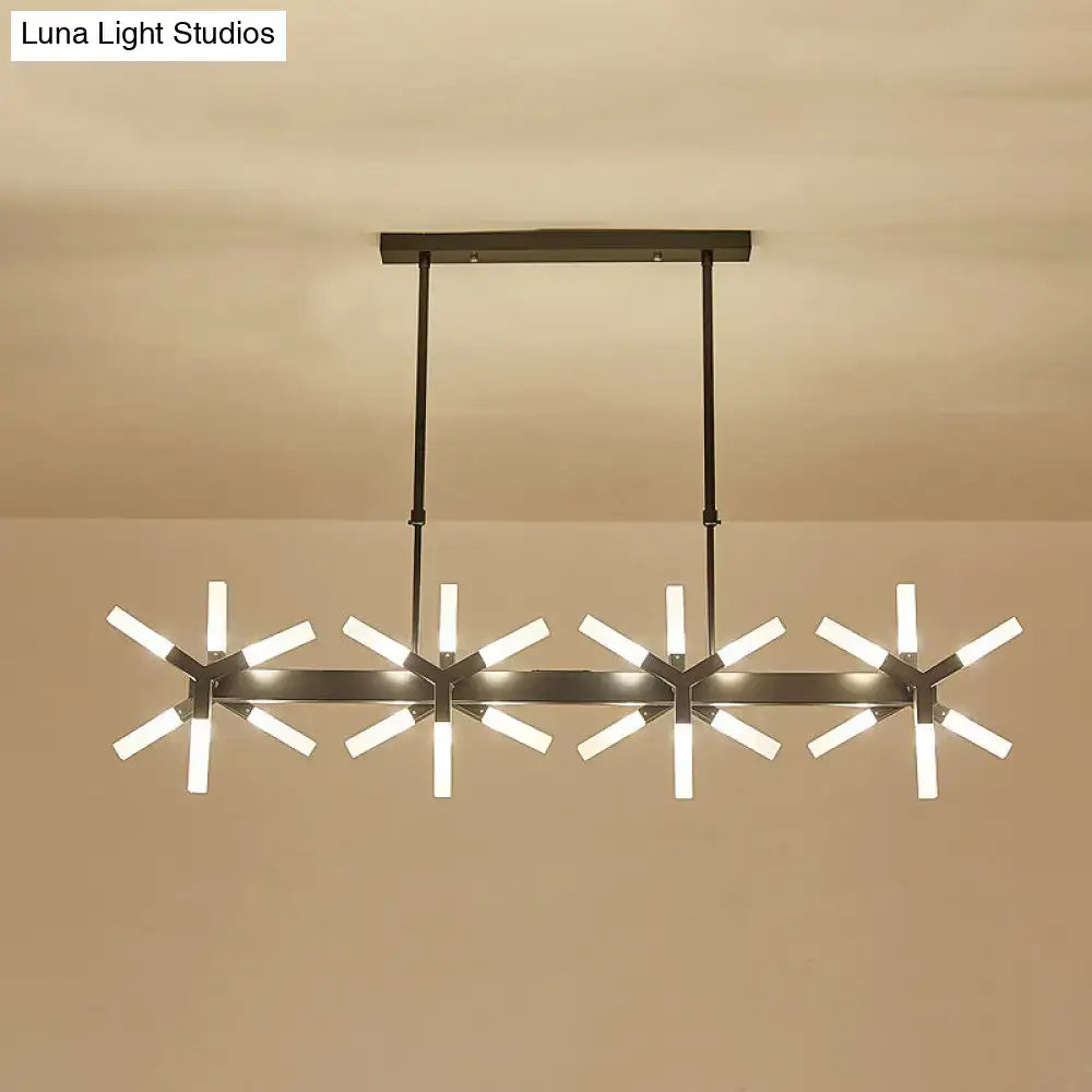 Modern black metal chandelier with four starburst lights and warm glow featuring linear acrylic shade ideal over island