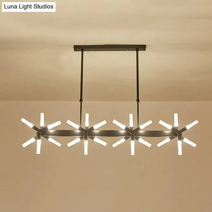 Modern black metal chandelier with four starburst lights and warm glow featuring linear acrylic shade ideal over island