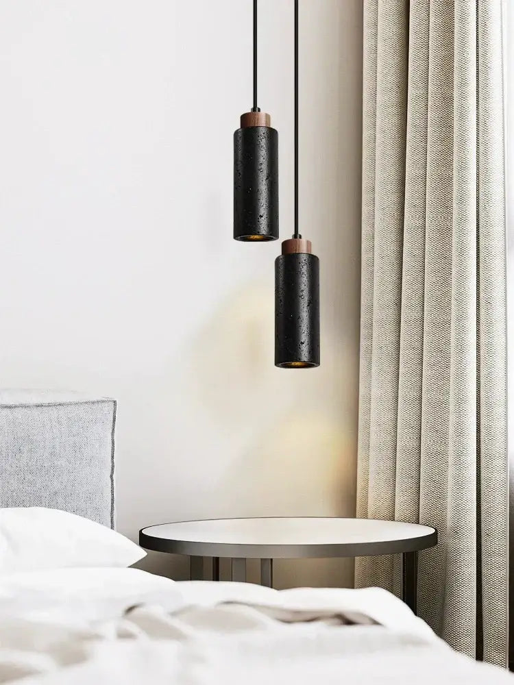 Modern black stone bedside chandelier featuring two black stone bedside cylindrical pendant lights with copper tops