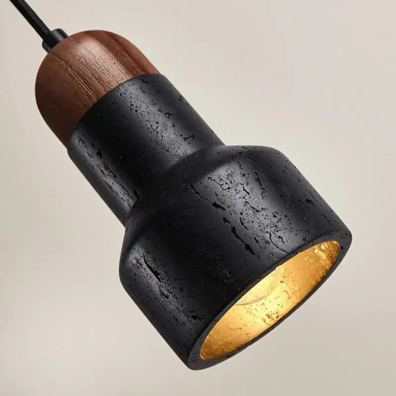 Modern black stone led pendant light with warm gold interior and wooden top cap for kitchen decorbites black stone decor