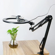 Modern black led ring light with swing arm and phone clamp designed as an adjustable mirror light for bedroom use