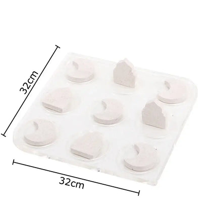 A clear plastic tray with nine light gray silicone molds for decorbites acrylic tic-tac-toe chessboard set decor