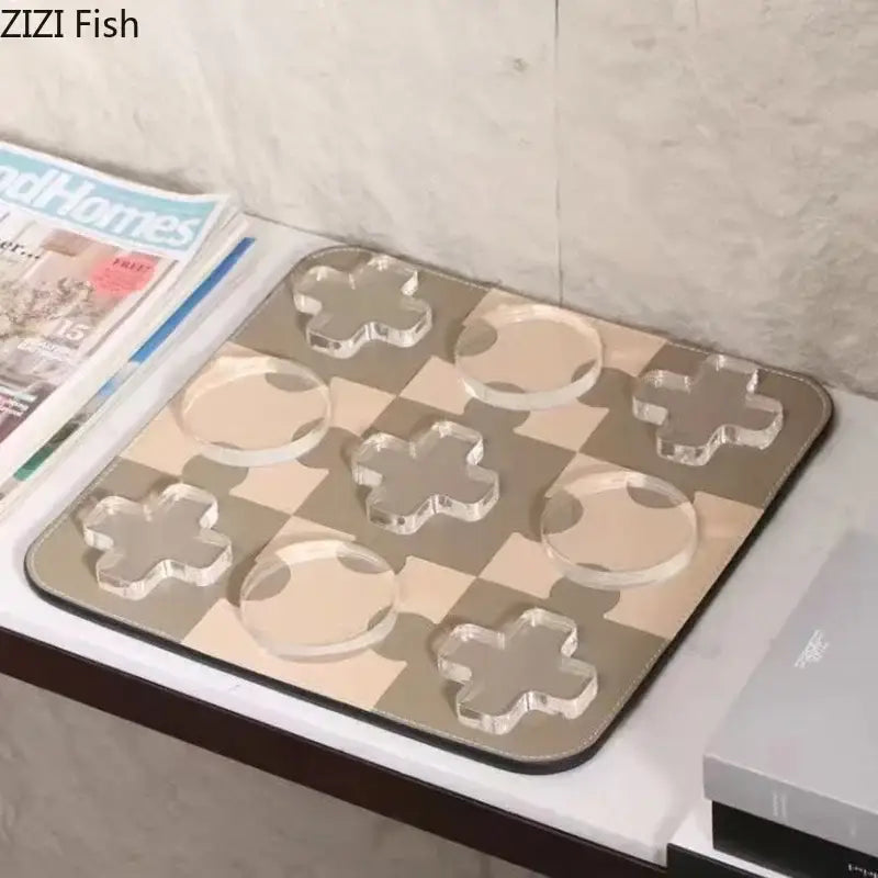 Modern black and tan acrylic chessboard set with clear cross and circle pieces on a beige and gray mat decorbites acrylic tic-tac-toe