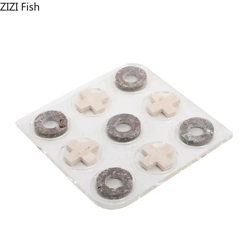 Set of nine gray and off-white stone-like pieces on clear tray in decorbites acrylic tic-tac-toe chessboard set