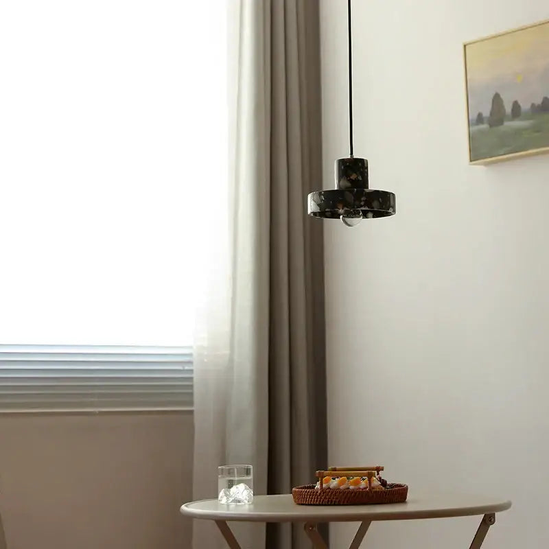 Modern black terrazzo led pendant lamp featuring a sleek black marble design hanging from a thin cord for dining room decorbites