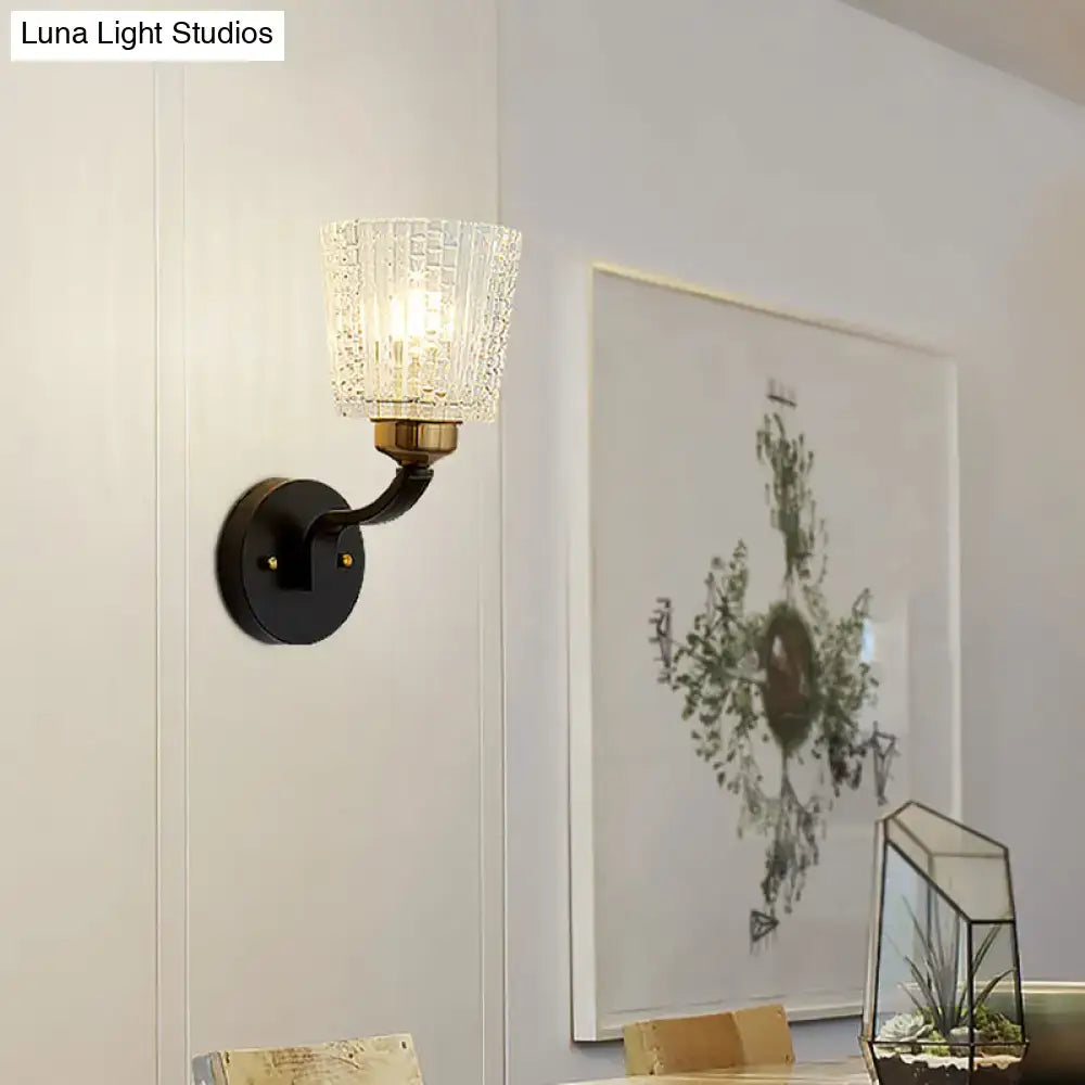 Modern black textured glass conical wall lighting bedroom sconce with brass accents and warm diffused light