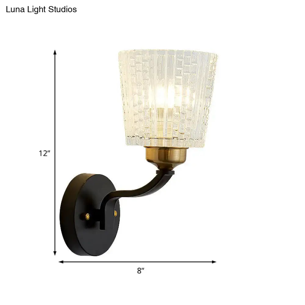 Modern black textured glass conical wall lighting with amber-gold accent and curved metal arm for bedroom sconce
