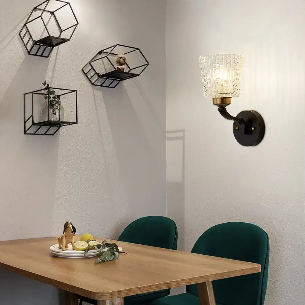 Modern black metal wall sconce with textured glass shade featuring conical wall lighting for bedroom decor