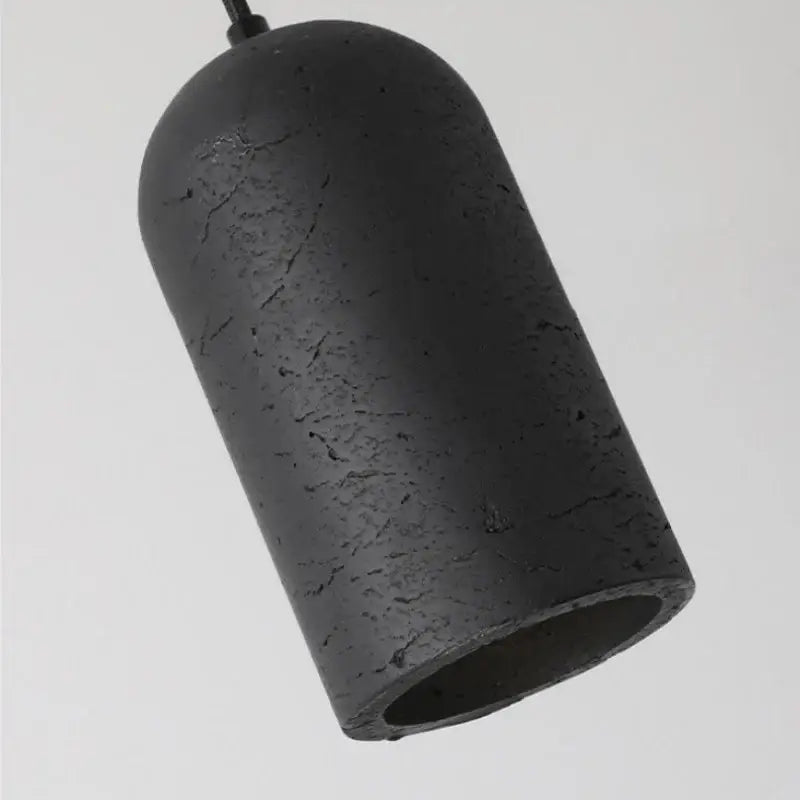 Modern black travertine led pendant lamp with textured cracked surface and gold interior lining for kitchen decorbites black travertine