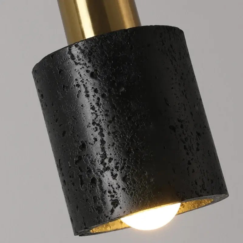 Modern black travertine led pendant light with textured concrete and brass finish for dining room decorbites black travertine