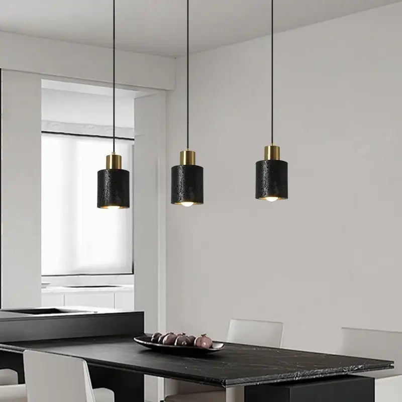 Three modern black travertine led pendant lights with gold accents for dining room decorbites black travertine design