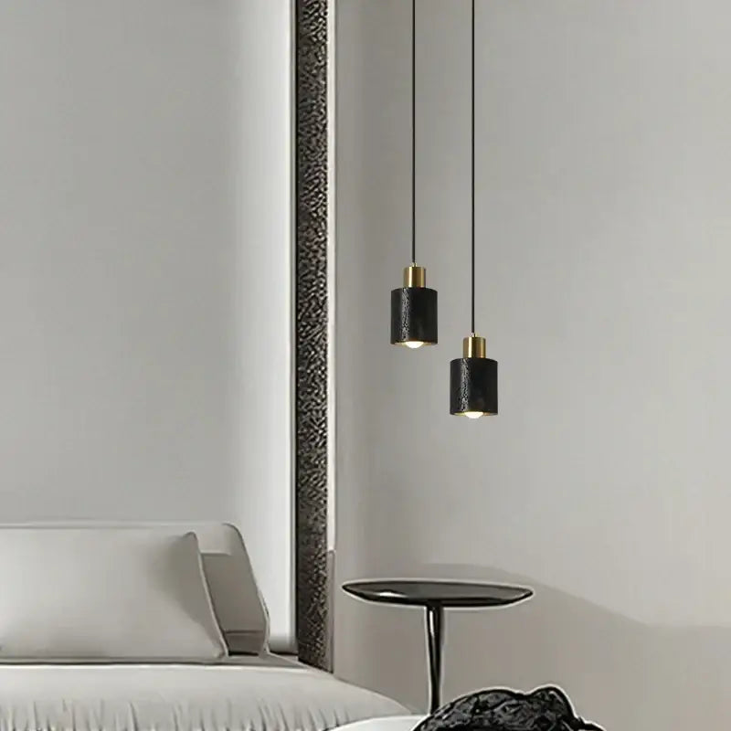 Modern black travertine led pendant light with gold accents casting warm glow in minimalist dining room decorbites black travertine