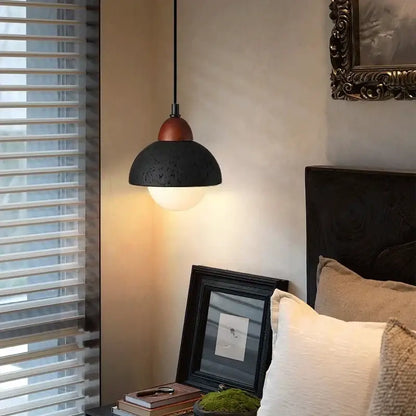 Modern black travertine pendant light with copper-toned top and warm diffused light for bedroom decorbites black travertine