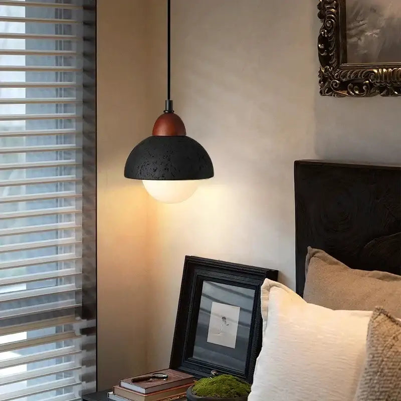 Modern black travertine pendant light with copper-toned top and warm diffused light for bedroom decorbites black travertine