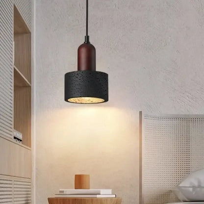 Modern black travertine pendant light featuring a black textured concrete shade with warm wooden accent for bedroom decorbites black travertine pendant