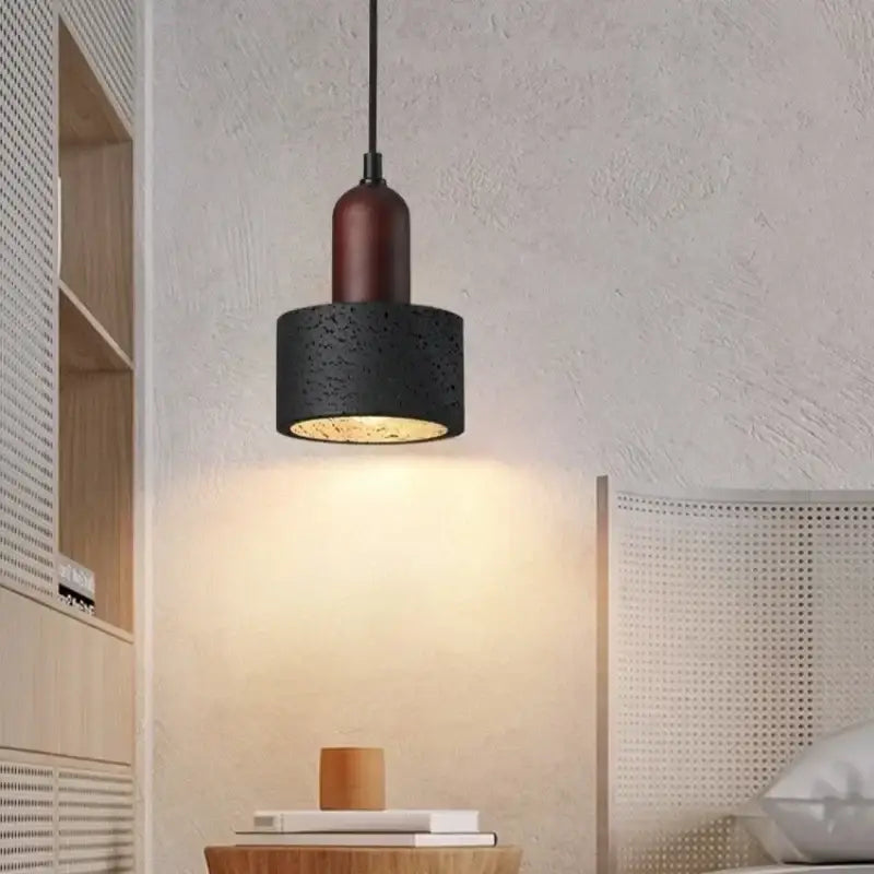Modern black travertine pendant light featuring a black textured concrete shade with warm wooden accent for bedroom decorbites black travertine pendant