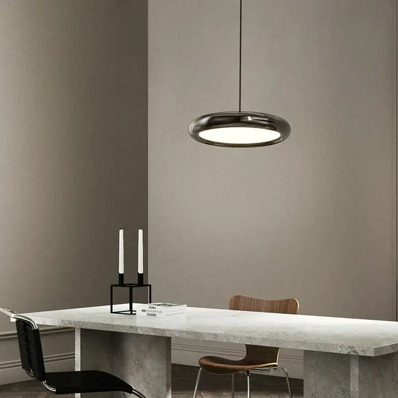 Modern black triple ring iron pendant chandelier with sleek circular design and frosted glass diffuser for kitchen lighting