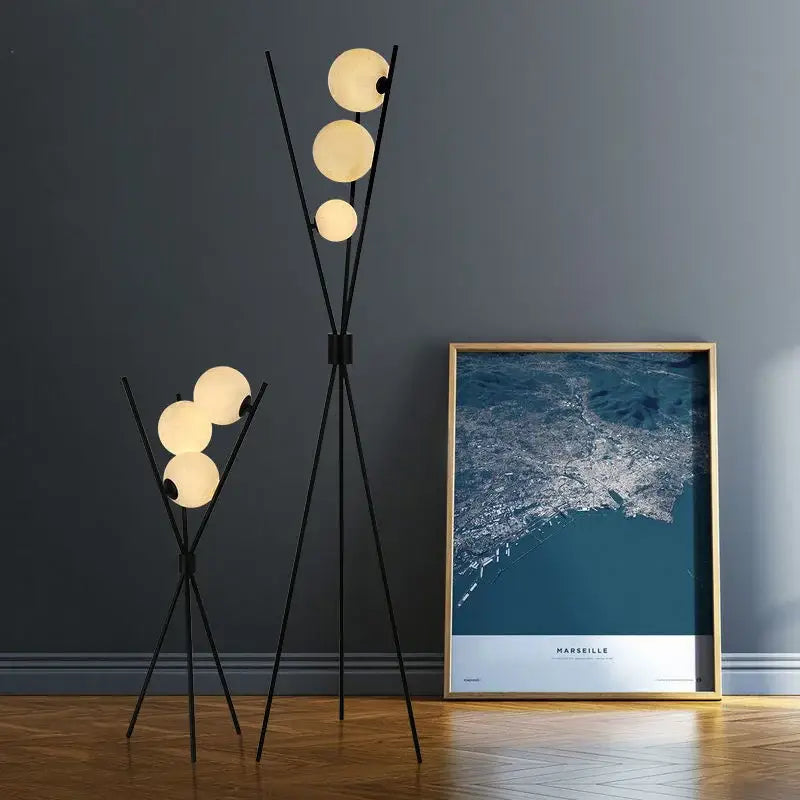 Modern black tripod moon floor lamp with three glowing spherical glass shades for stylish living room decorbites moon floor use