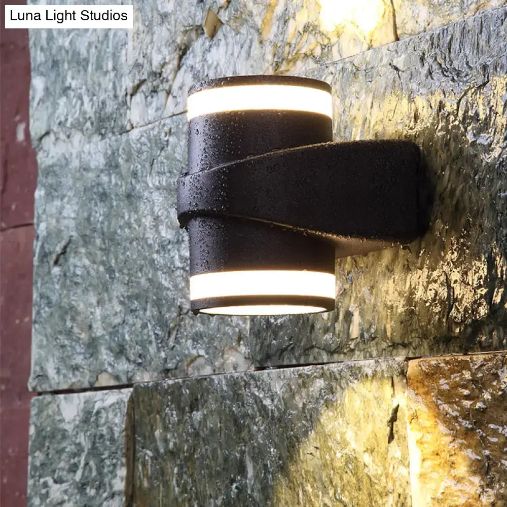 Modern black tubular metal wall washer sconce with two horizontal led strips emitting warm light for backyard use