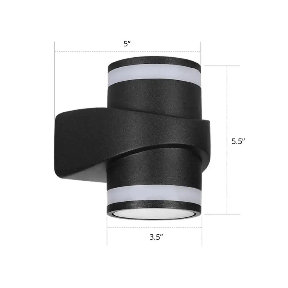 Modern black tubular metal wall washer sconce with a sleek twisted design for outdoor backyard lighting