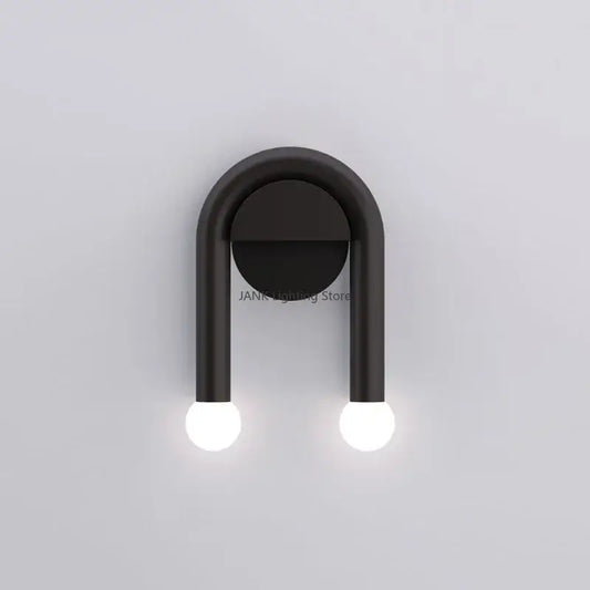 Modern black u-shape led wall lamp with two spherical bulbs designed as an indoor minimalist bedroom sconce