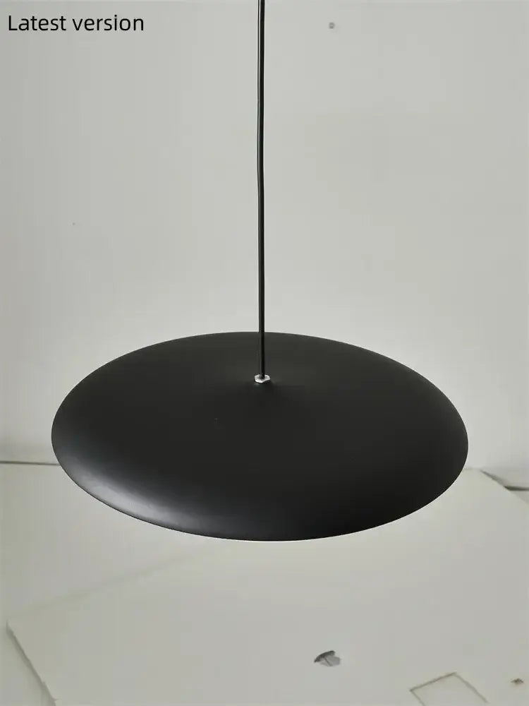 Modern black pendant light with matte finish and sleek minimalist design as a stylish dining room light source