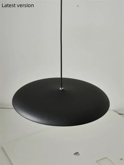 Modern black pendant light with matte finish and sleek minimalist design as a stylish dining room light source