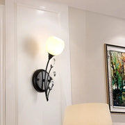 Modern black wall sconce light with wrought iron frame frosted glass globe and crystal accents for living room wall lamp