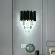 Modern black wall sconce with clear crystal prisms and layered fan-like shades for elegant bedroom lighting
