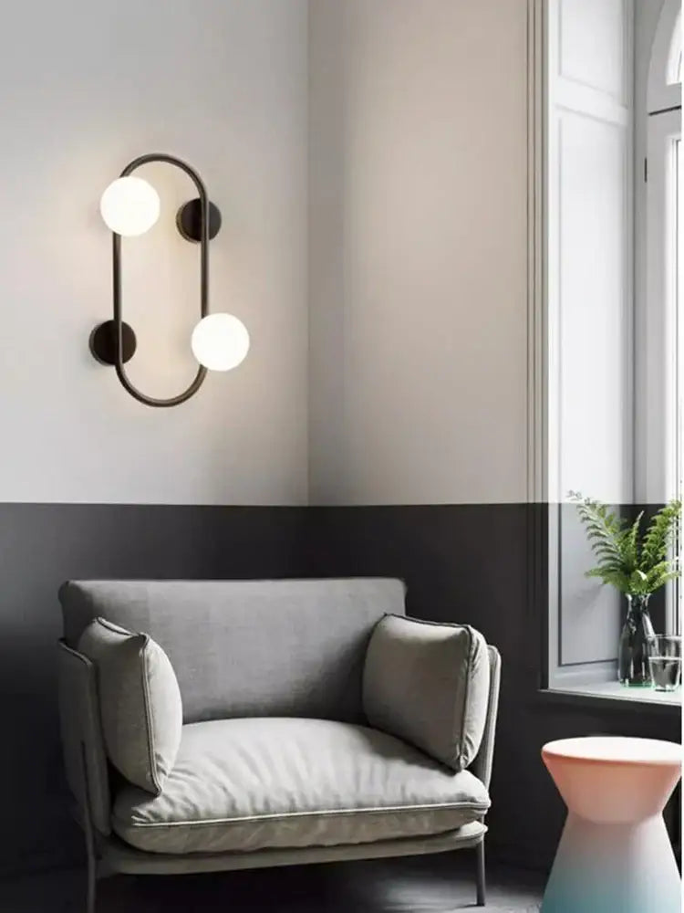 Modern black metal wall sconce with two frosted glass globe bulbs ideal for bedroom light and decorbites brass led wall decor