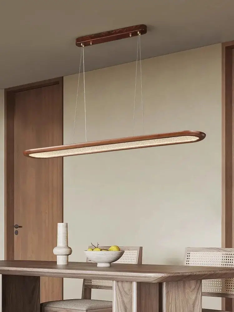 Modern black walnut wooden dining room led pendant lamp with sleek elongated rectangular design and warm ambient glow ceiling chandelier decorbites black walnut