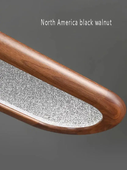 A sleek curved nail file with a black walnut wooden handle and textured metal surface for decorbites black walnut style