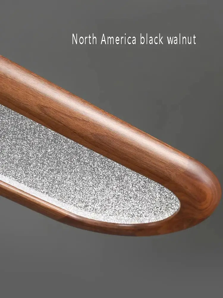 A sleek curved nail file with a black walnut wooden handle and textured metal surface for decorbites black walnut style