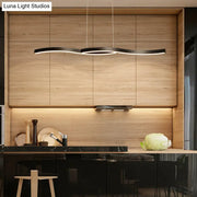 Modern black wave led hanging light fixture with sleek metallic finish above kitchen counter as hanging light fixture