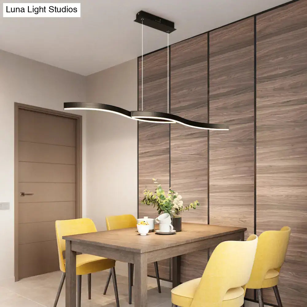 Modern black wave led hanging light fixture with sleek wavy design as a kitchen pendant hanging light fixture above table