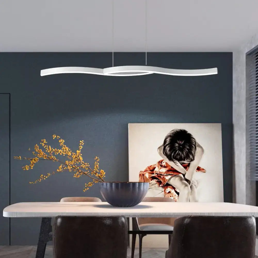 Modern white led hanging light fixture with a sleek wavy design above dining table in kitchen pendant style