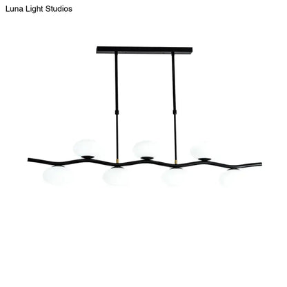 DecorBites modern black wavy pendant light with five white glass ceiling globes and extendable rods for island lighting