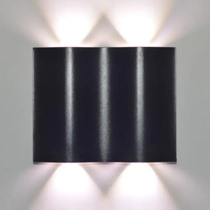 Modern black rectangular wall washer lamp with three vertical ridges and warm white lighting for porch use