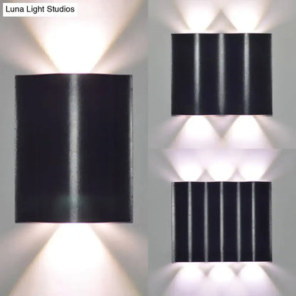 Modern black rectangular wall washer lamp with vertical ridges and three downward warm white lighting lights for porch