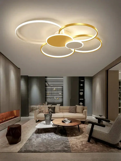 Modern black and white acrylic chandelier light featuring a gold and white circular led ceiling fixture with a cloud-like design