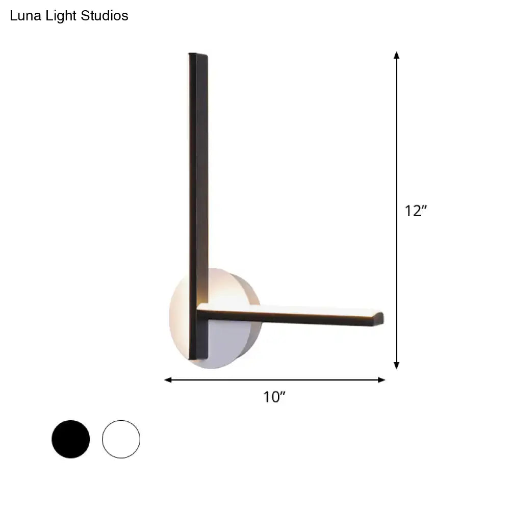 Modern black and white acrylic cross wall sconce with sleek metal frame and warm white circular diffuser for bedroom use