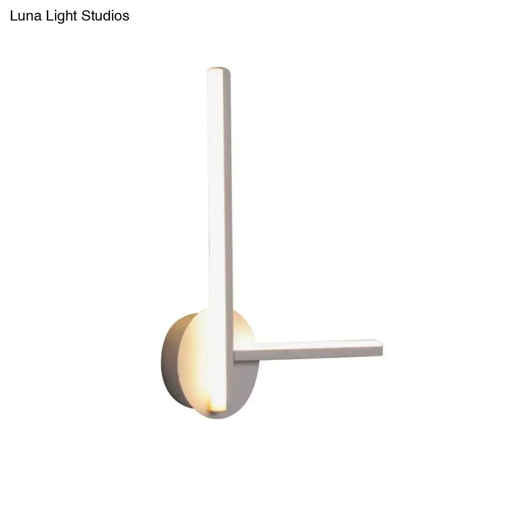 Minimalist white acrylic cross wall sconce with sleek modern design and warm white light for bedroom use