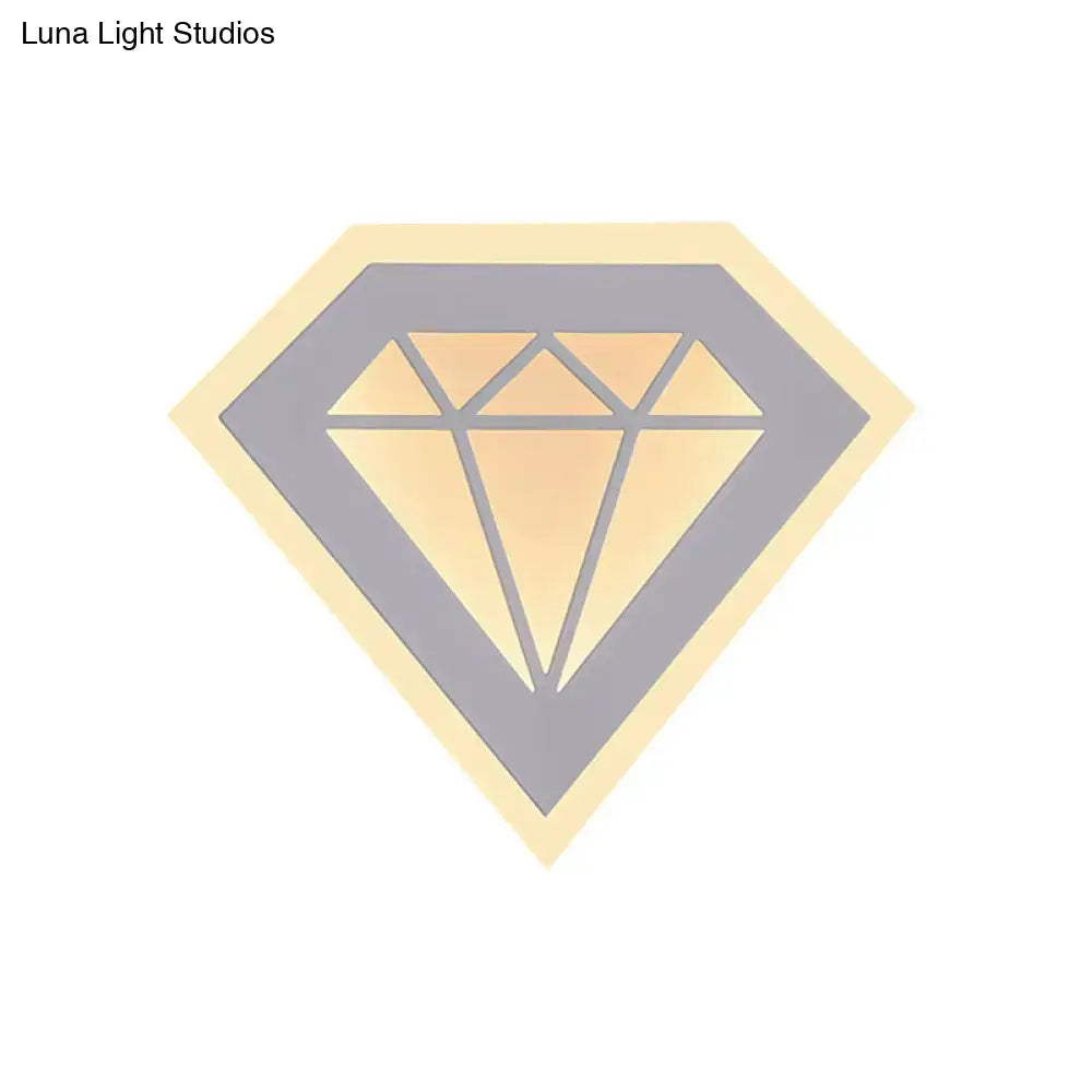 Stylized gold diamond-shaped sticker with gray outline and yellow border on modern acrylic diamond bedside wall lamp
