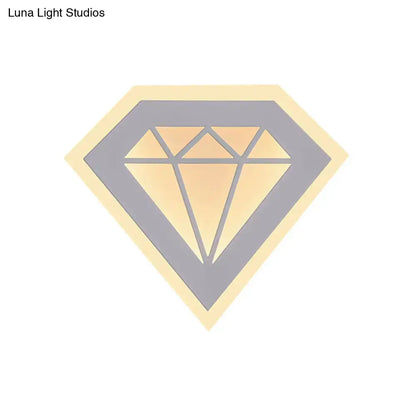 Stylized gold diamond-shaped sticker with gray outline and yellow border on modern acrylic diamond bedside wall lamp
